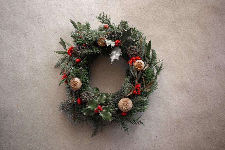 A Christmas wreath on a plain background.
