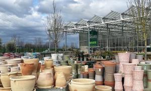 Image shows a range of large ceramic plant pots for sale outside at the Arium